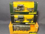 three boxed boxed boxed model trucks sitting on top of each other