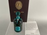 a bottle of perfume sitting on a table with a box