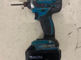 a close up of a cordless drill on a table