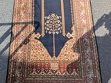 une image représentant un tapis posé au sol, avec l'ombre d'une personne