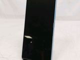 a close up of a cell phone on a stand on a white surface