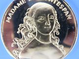 a close up of a coin with a woman ' s face on it