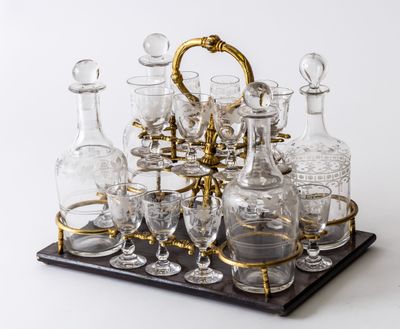 a tray with a lot of glasses and decanters on it