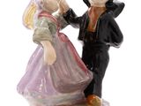 a figurine of a man and a woman standing next to each other