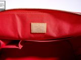 the inside of a red handbag with a leather label on it