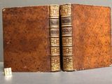 two old books that are sitting on a table