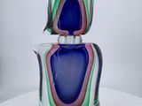 two glass vases stacked on top of each other on a table