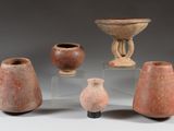 several pieces of pottery sitting on top of a table next to each other