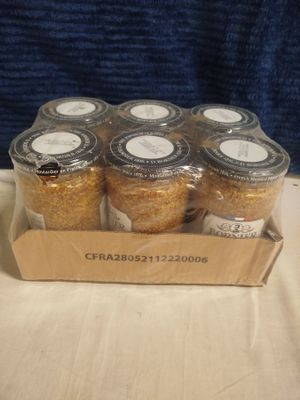 six jars of cereal sit in a cardboard box on a table