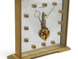 a clock that has a key on it in a glass case