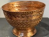 a gold bowl sitting on top of a black table