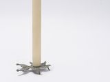 candles are lit on a white table with a white background