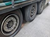 a large truck with a flat tire parked on the side of the road