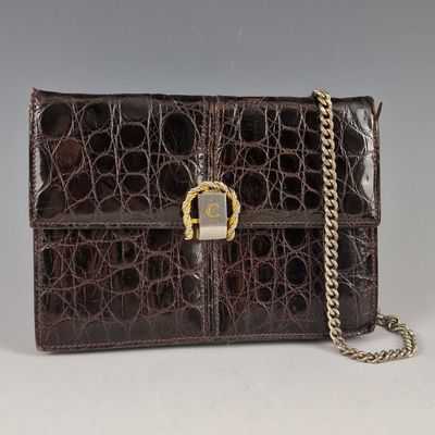 an image of a brown purse with a chain on it