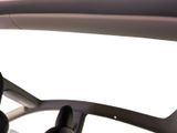 a car dashboard with a steering wheel and a cell phone in it