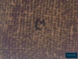 a black bird that is sitting on a brown surface