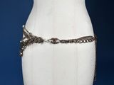 a close up of a mannequin torso with a chain around it