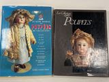 two books of dolls are sitting on a table next to each other