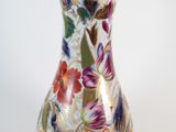 a vase with a floral design on it sitting on a table