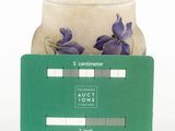 purple flowers in a glass jar with a credit card in front of it