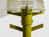 a close up of a street light with a plastic container on it