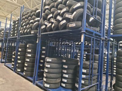 many tires stacked on a rack in a warehouse