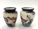 pair of asian vases with a woman and a dog on them