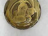 a small bowl with a horse on it on a white surface