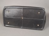 a black purse that is sitting on a table
