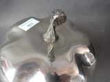a silver plate with a bird on top of it