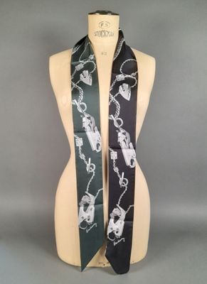 a mannequin with a black and white scarf on it