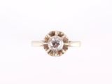 a close up of a diamond ring on a white background