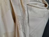 a close up of a white dress with a quilt on it