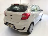 a white car that is parked in a white room