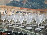 many wine glasses lined up on a marble counter