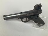 a close up of a gun on display on a white surface