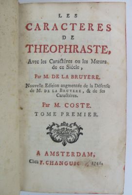 an old book that is open on a table