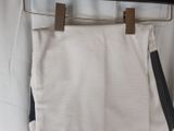 the pants are hanging on the clothes rack in the closet