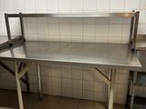 a large stainless steel table in the kitchen