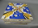a stack of books that have been painted with blue and yellow designs