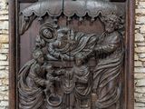 a wooden relief of the nativity of jesus and mary on a stone wall