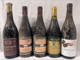 several bottles of wine are lined up on a table