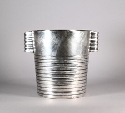a silver vase that is sitting on a table