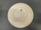 a white plate with a black design on it