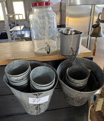 many buckets of water sitting on a table