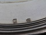 a close up of a silver plate with a clock on it