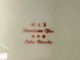 a white plate with a red and black design on it