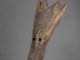 a close up of a wooden object on a gray surface