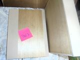 a cardboard box with a pink post - it note on it