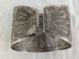an image of a silver cuff bracelet on a white cloth